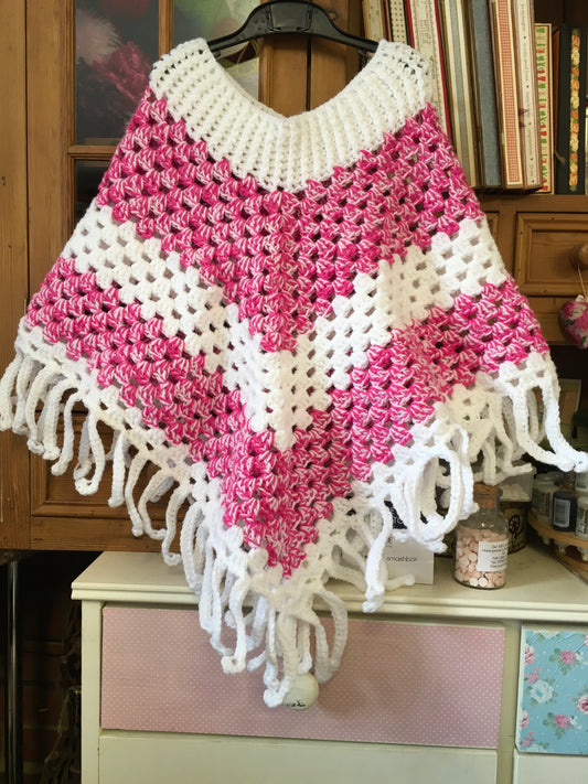 Hand crocheted child’s poncho. Pink and white mix. Approx age 8-12.